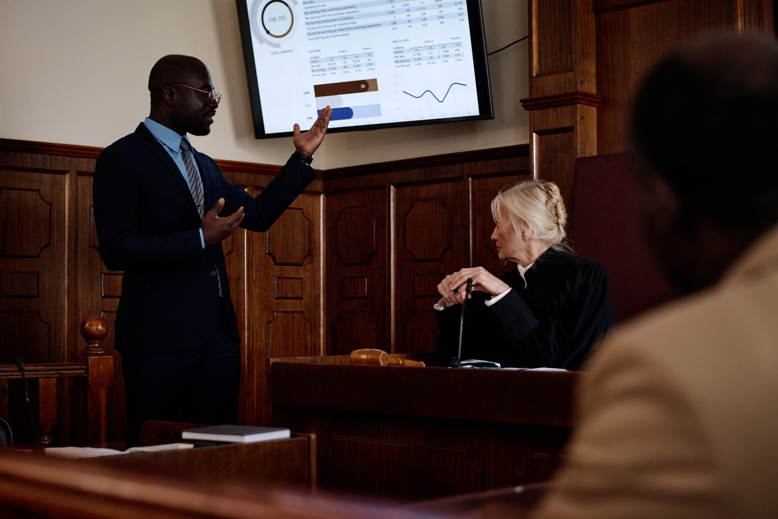 confident male lawyer pointing at screen with summary of results